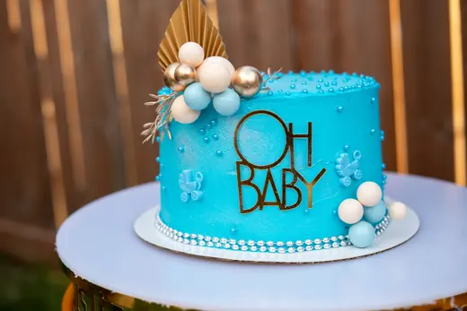 Blue baby celebration cake with balloon details