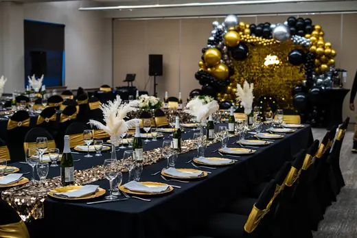 Black and gold banquet table styling