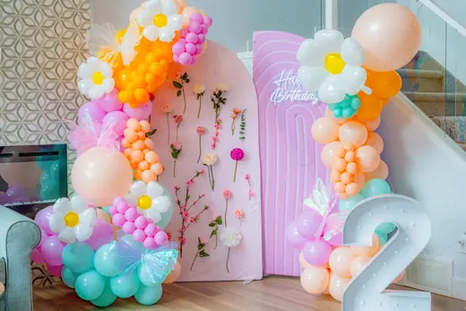 Colourful floral and balloon second birthday backdrop