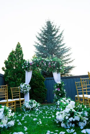 Outdoor ceremony aisle with white floral decor