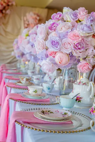 Pastel floral reception table with pink place settings