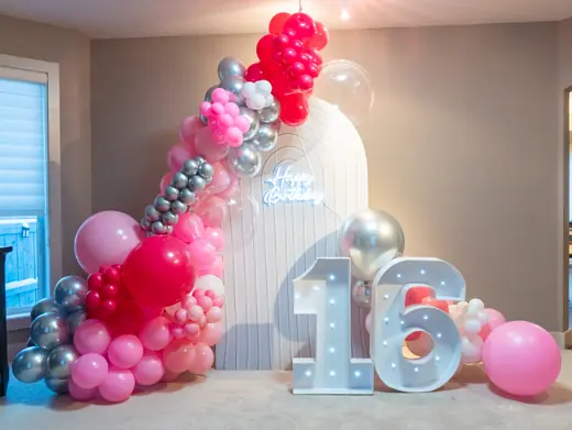 Pink and black Sweet 16 balloon backdrop
