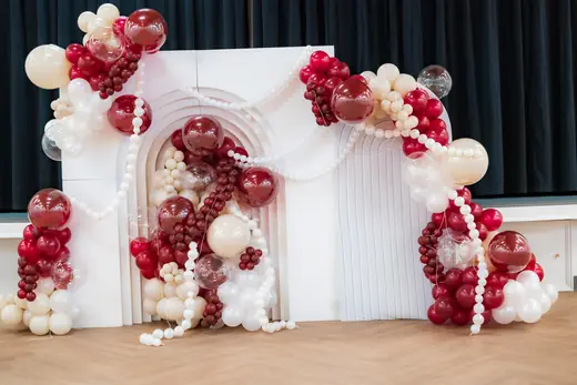 Red and cream balloon celebration backdrop