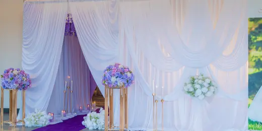 White draped floral event backdrop
