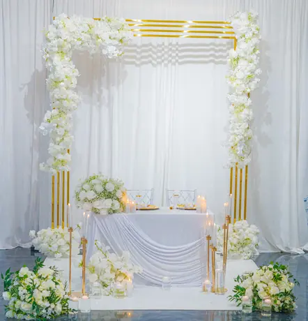 White floral arch with soft draping