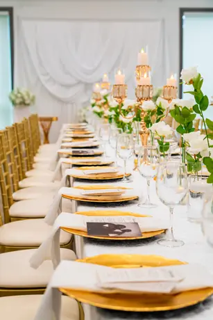 White and gold formal place setting with florals